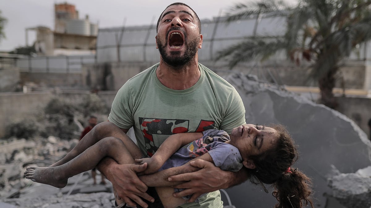 (Trigger warning: image depicts death) A Palestinian man cries out holding the body of his cousin, who he pulled from the rubble after Israeli airstrikes in Gaza (photo: Images)