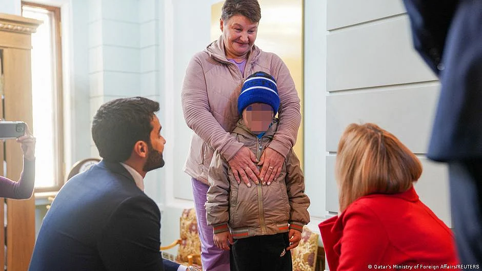 A 7-year-old Ukrainian boy, who is the first child released under a new mechanism Qatar has set up with the goal of repatriating children from Russia to Ukraine, stands with his grandmother (photo: DW)