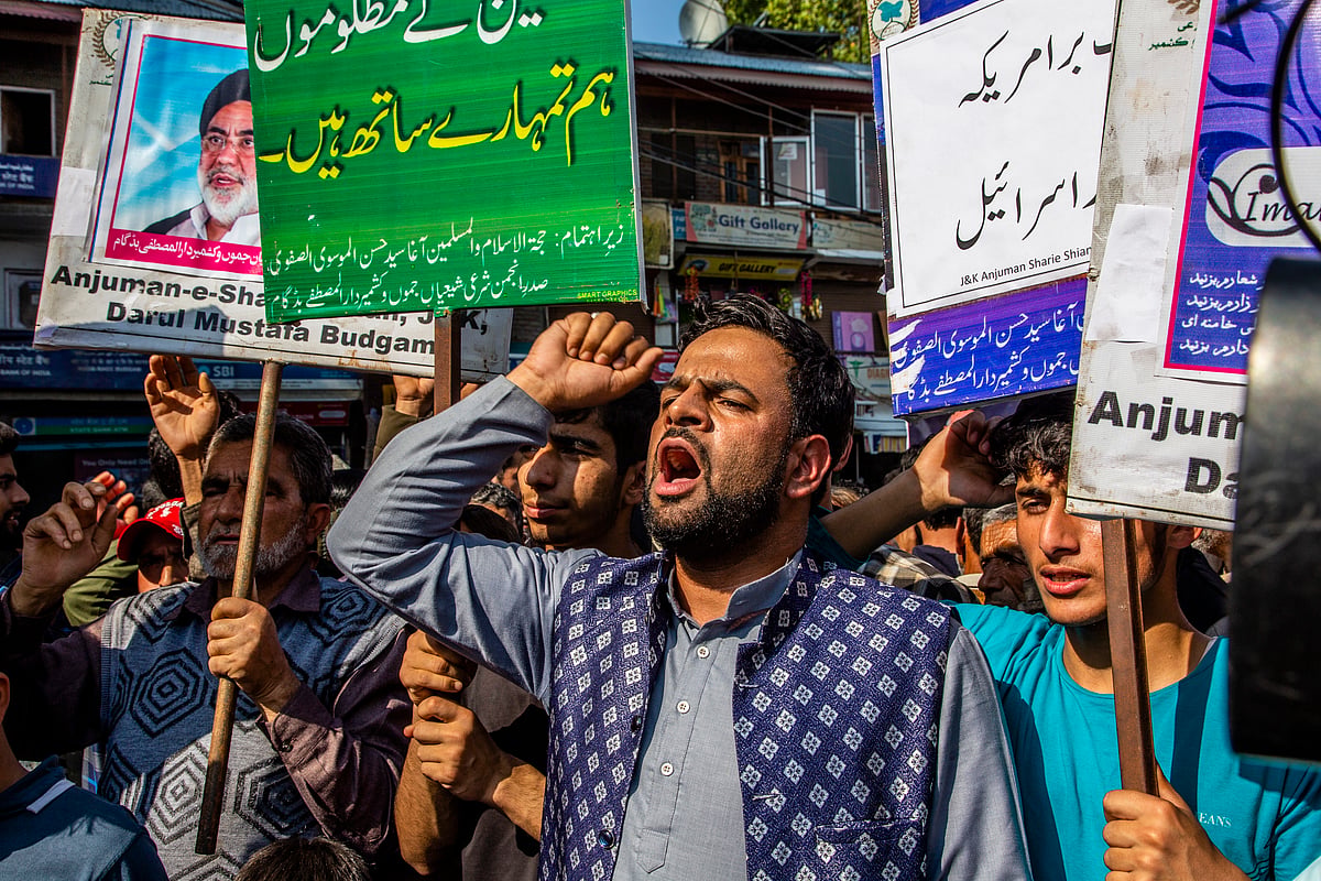 "We stand with the oppressed people of Palestine," reads a placard held by a Kashmri protestor, on 13 October in Budgam, Kashmir (photo: Getty Images)