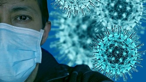 Post-Covid risk analysis needed, as study shows elevated risk of autoimmune disorders like psoriasis and vasculitis too. Representative image of a masked person against a backdrop of the magnified coronavirus (photo: IANS)