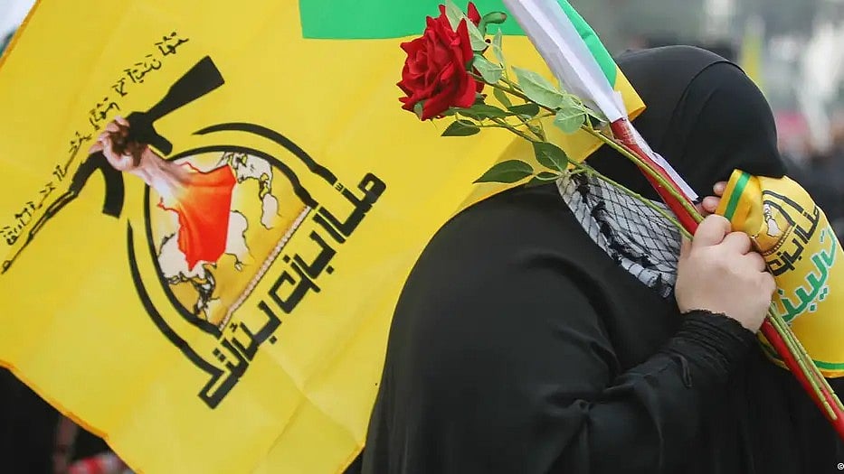 A Hezbollah supporter carries a flag in the group's green and yellow colours (photo: Getty Images)
