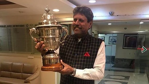 Kapil Dev holding the 1983 ICC World Cup at BCCI office in Mumbai. (photo: @therealkapildev/X)
