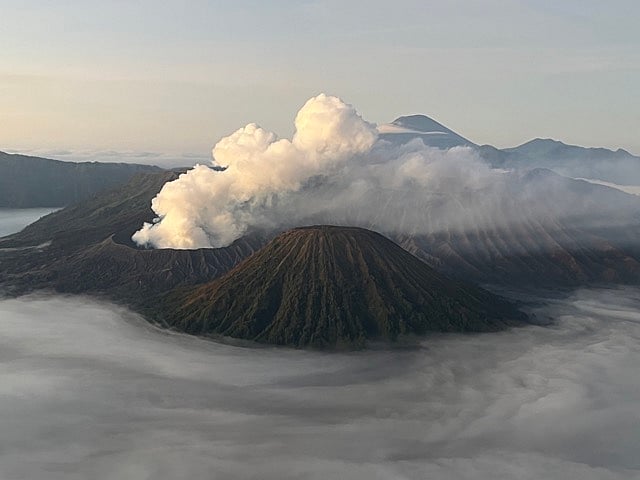View of Mt Bromo (foreground) and Mt Semeru (background) from atop Mt Penanjakan in East Java (photo courtesy Timira)