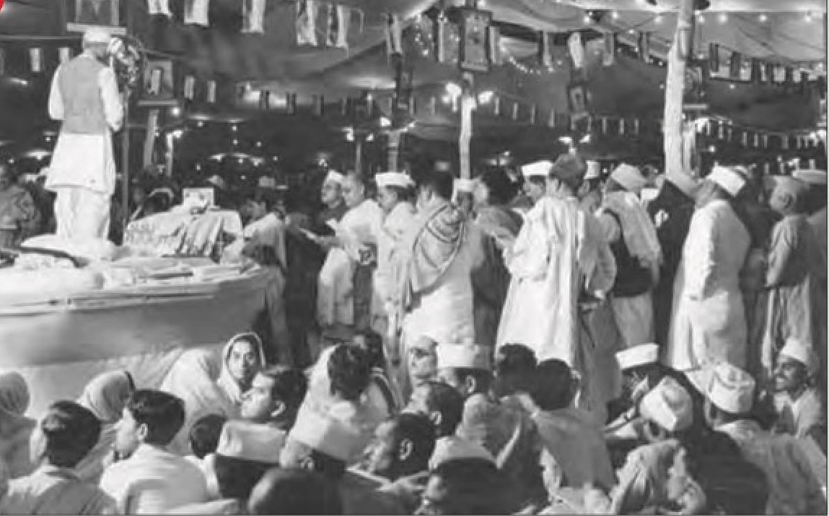 1929: The Poorna Swaraj resolution is adopted at the Lahore session of the Congress. Jawaharlal Nehru is seen speaking on the dais, with his back to the viewer, and other Congress members standing and sitting around (photo: National Herald archives) 