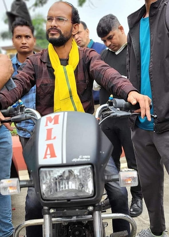 Astride his two-wheeler at the assembly (photo: National Herald)