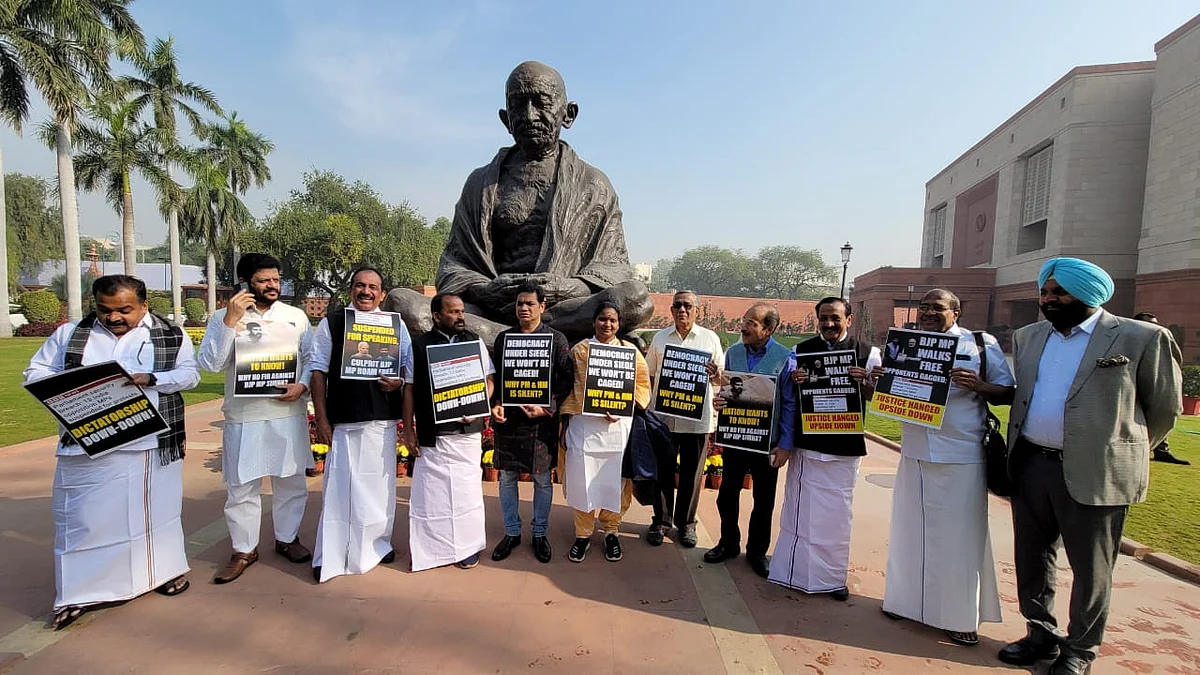 Opposition INDIA alliance leaders protest their suspensions near the Gandhi statue in the Parliament complex (photo: @SitaramYechury/X)