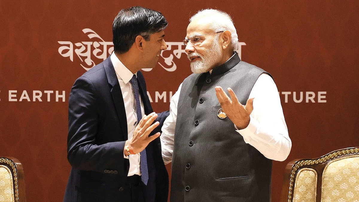 UK prime minister Rishi Sunak and his Indian counterpart Narendra Modi have an animated discussion with their gestures mirroring each other's against a backdrop with the legend 'vasudhaiva kutumbakam' (photo: Dan Kitwood/Getty Images)
