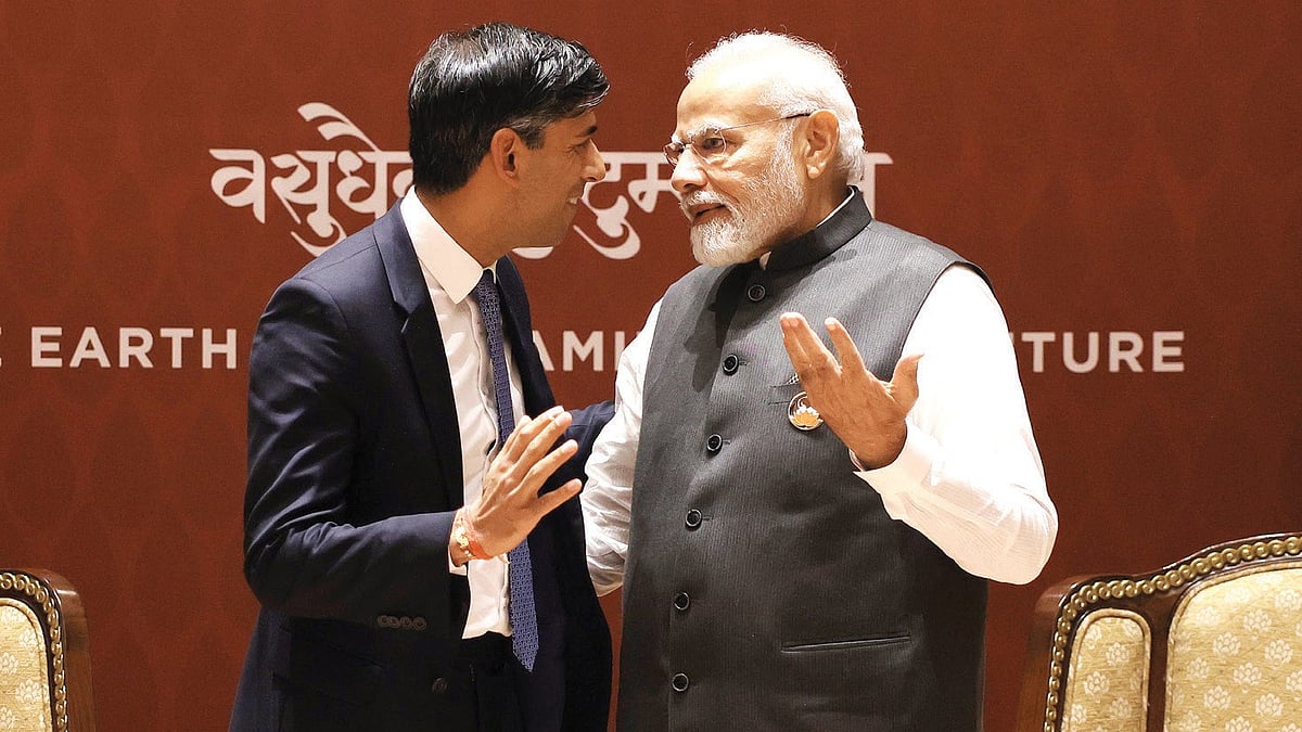 UK prime minister Rishi Sunak and his Indian counterpart Narendra Modi have an animated discussion with their gestures mirroring each other's against a backdrop with the legend 'vasudhaiva kutumbakam' (photo: Dan Kitwood/Getty Images)