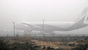 'War rooms' have been set up at Delhi airport to resolve complaints of passenger inconvenience in real time. Representative image shows a plane parked in smoggy air at the Indira Gandhi International Airport (photo: IANS)