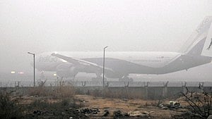 'War rooms' have been set up at Delhi airport to resolve complaints of passenger inconvenience in real time. Representative image shows a plane parked in smoggy air at the Indira Gandhi International Airport (photo: IANS)