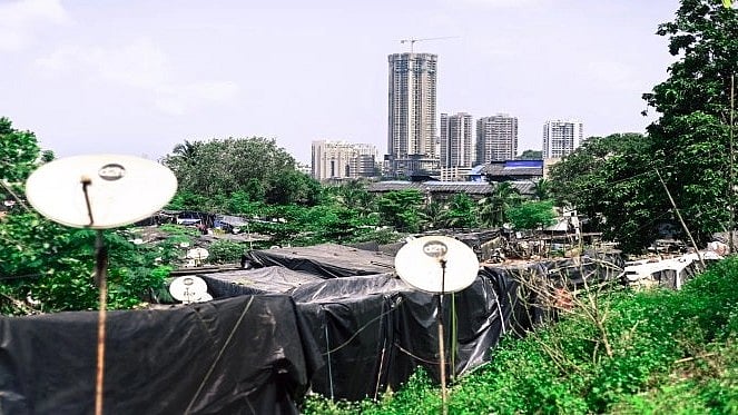 Representational photo showing slums with high-rise apartments in the background. (Photo Source: Oxfam India Report)