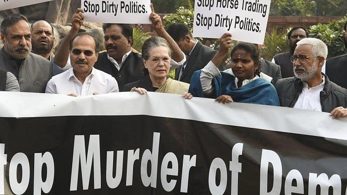 Congress president Sonia Gandhi participates in an Opposition protest against the Modi govt at Parliament House in November 2019, holding a banner that says 'Stop Murder of Democracy' (photo: National Herald Archives)