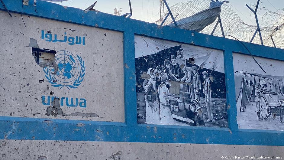 A broken signboard has the UNRWA logo in Hebrew and English, alongside images of activities the agency carries out in Palestine & Israel (photo: DW)