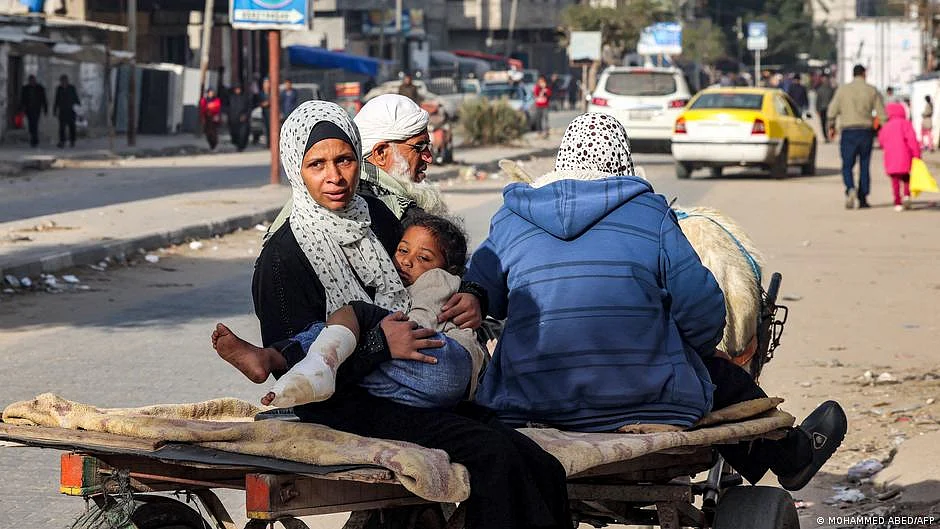 A family on a horse-drawn cart with a small injured child, bandages covering one leg, in Rafah, Gaza (photo: DW)