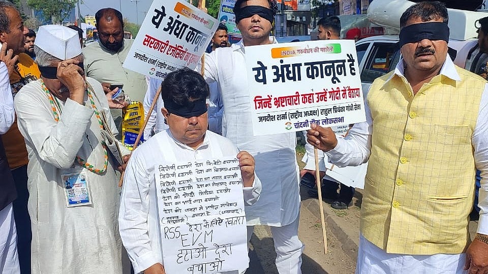 I.N.D.I.A. bloc supporters protest against the BJP government with blindfolds on in a reference to 'andha kanoon' (justice is blind)