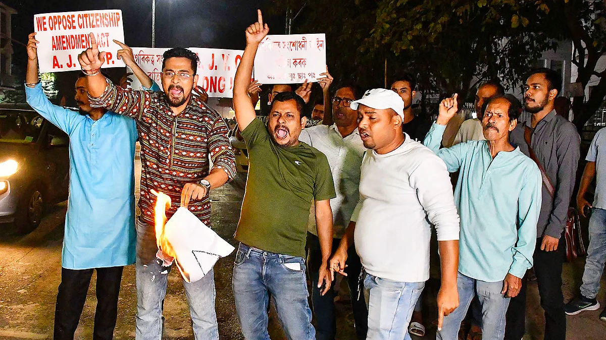 Protestors burn copies of the CAA in  Assam's capital Gauhati (photo: PTI)