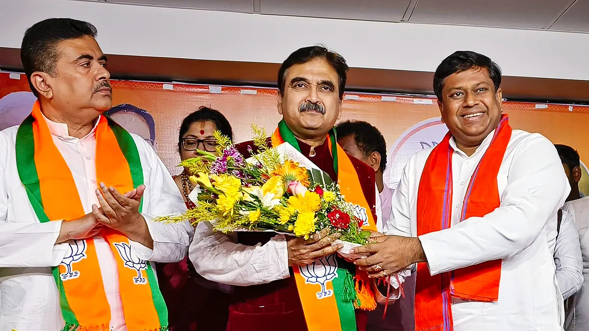 Abhijit Gangopadhyay (centre) joining the Bengal BJP as Suvendu Adhikari (far left) and Sukanta Majumdar cheer him on (photo: PTI)