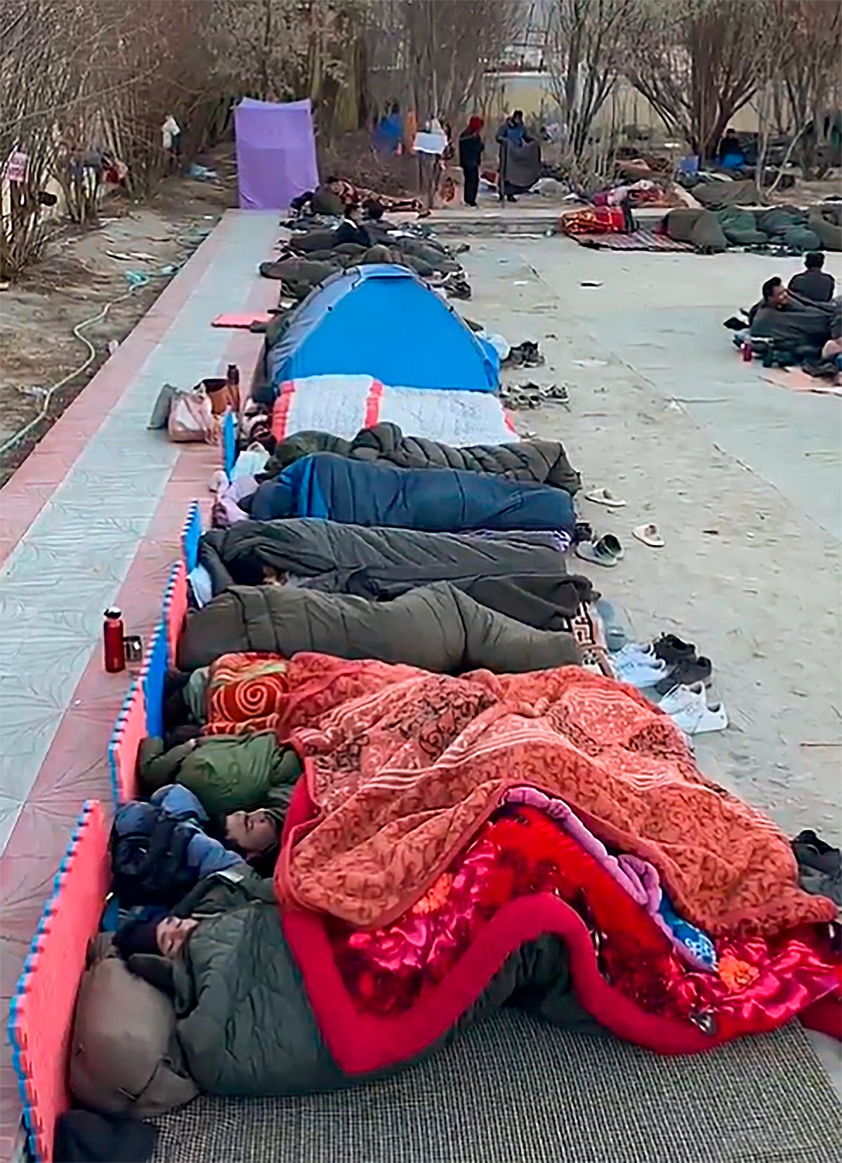 Supporters join Wangchuk at the protest site, bundled up in sub-zero temperatures and huddled together on the ground to share the little warmth (photo: PTI)