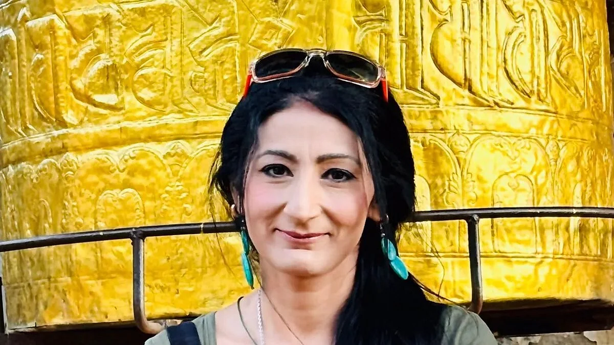Professor Nitasha Kaul of the University of Westminster, UK, stands before a Buddhist prayer wheel (photo courtesy @sabasti33712705/X) 