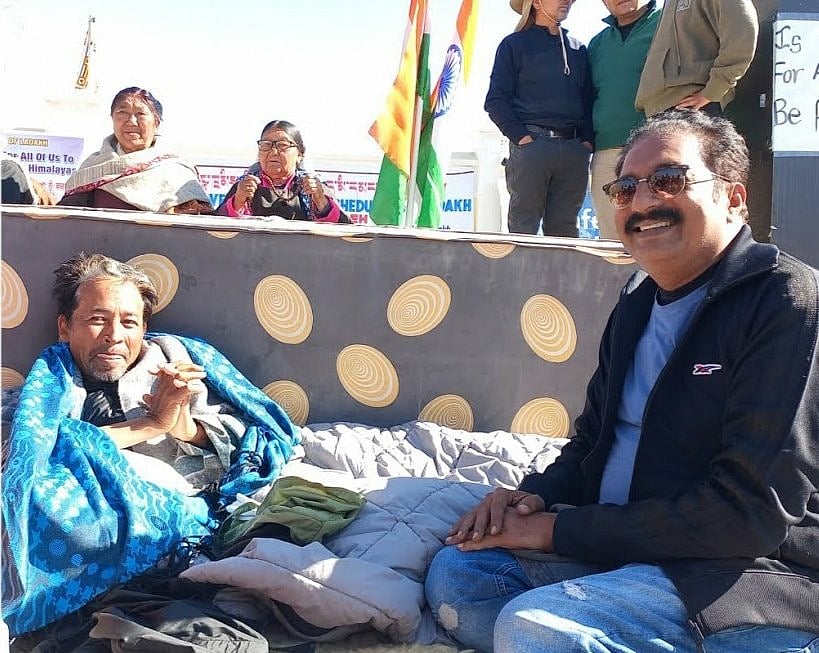 Actor Prakash Raj (right), a vociferous critic of the BJP, smiles with Sonam Wangchuk (bottom left) (photo: PTI)