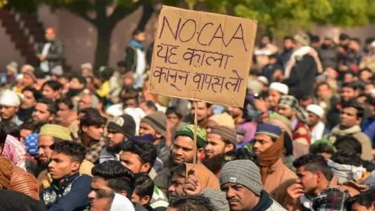 A protest against the CAA, with a placard calling for this 'black law' to be rolled back (photo: National Herald archives) 