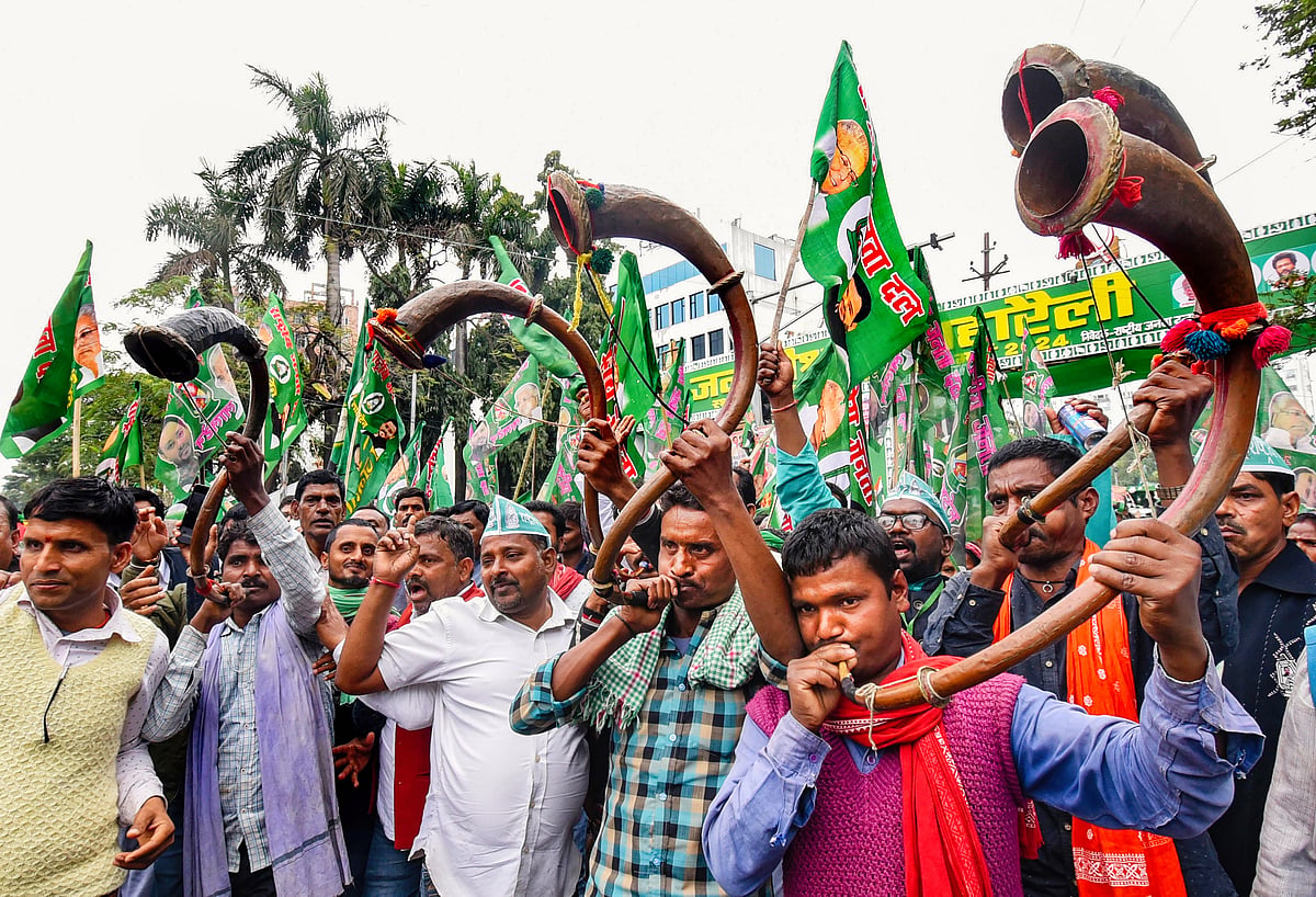 RJD supporters blow bugles at the rally (photo: PTI)
