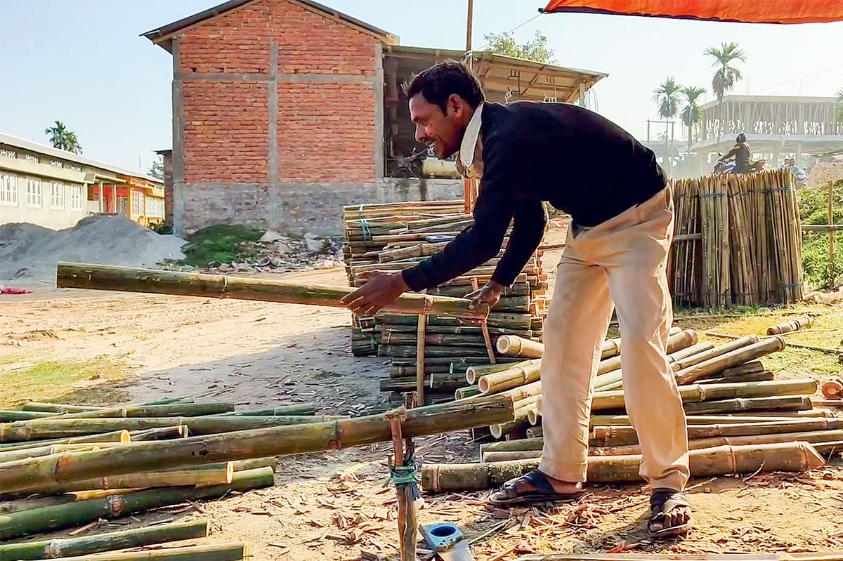 Munser Ali, here sorting and cutting up bamboo lengths, has lost many of his key customers—the basket makers, who can no longer afford it