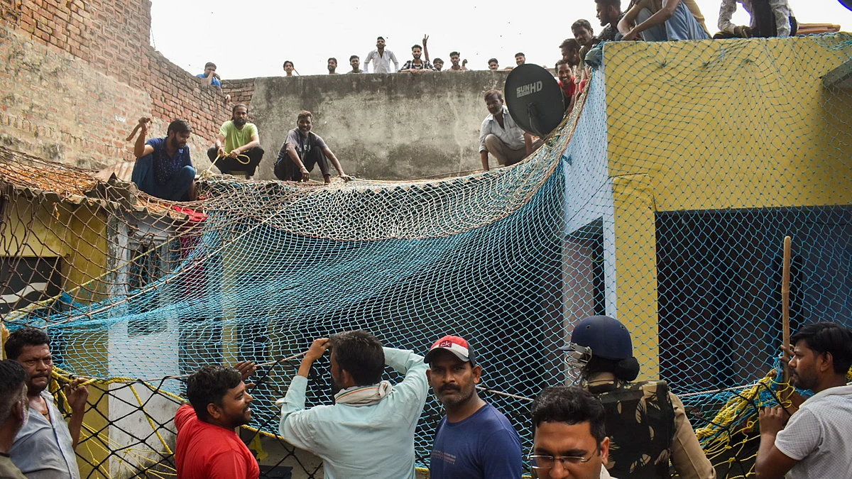 The DFO said the house was covered with nets from all sides and a wall was broken to safely rescue the family (photo: PTI)