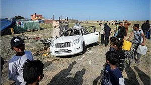 A car damaged in the attack (photo: IANS)