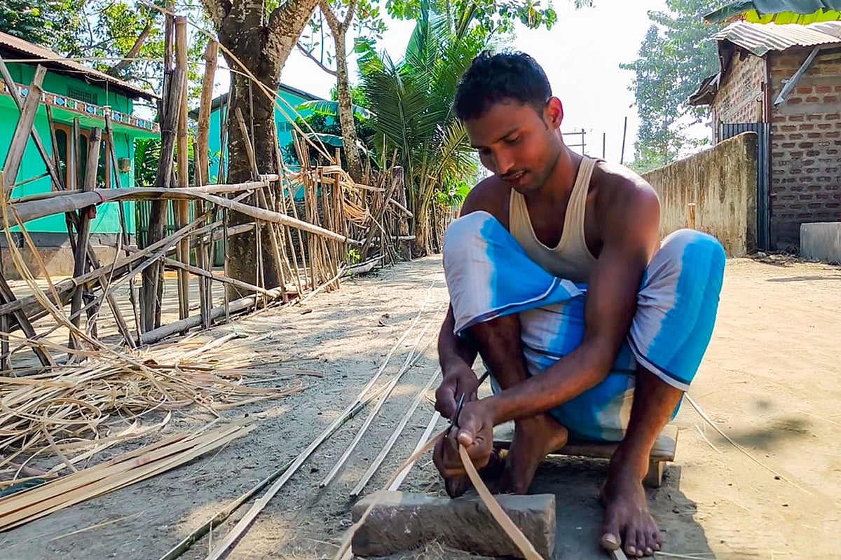 Siraj Ali, here slicing the bamboo into strips for weaving, makes Rs 250-300 a day. Many of his family members have left for the Karnataka coffee estates