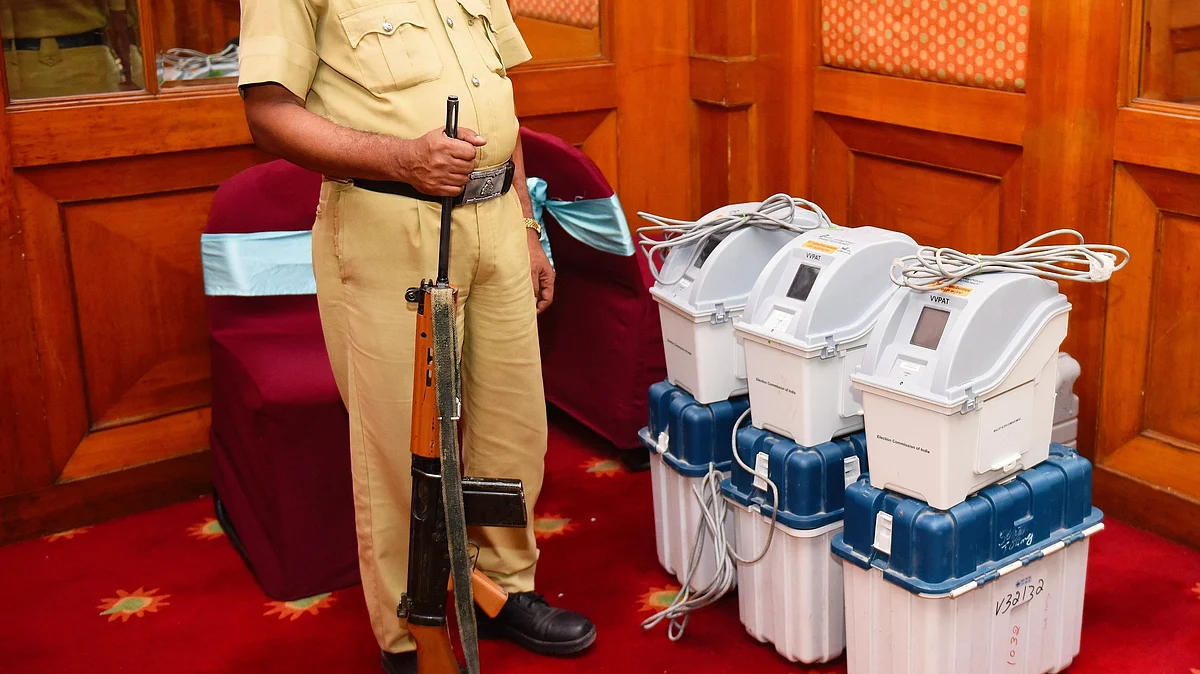 A policeman guards a set of VVPAT (voter-verified paper audit trail) machines during a demo session by the Election Commission in Bengaluru (photo: National Herald archives)