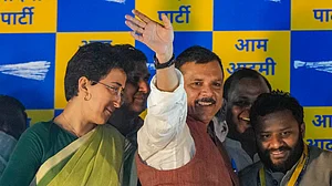AAP leader Sanjay Singh with Delhi Minister Atishi acknowledges supporters upon his arrival at the party office after his release from Tihar Jail, 3 April (photo: PTI)