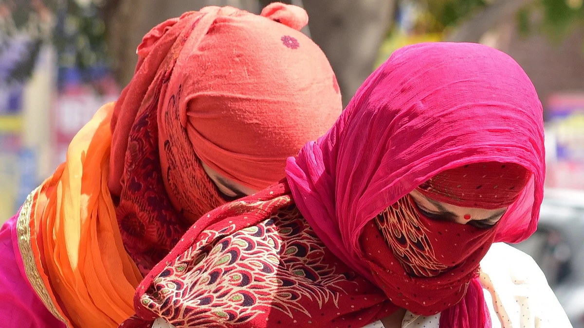 Women cover their faces to avoid scorching sun on a hot day. (File Photo: IANS)  