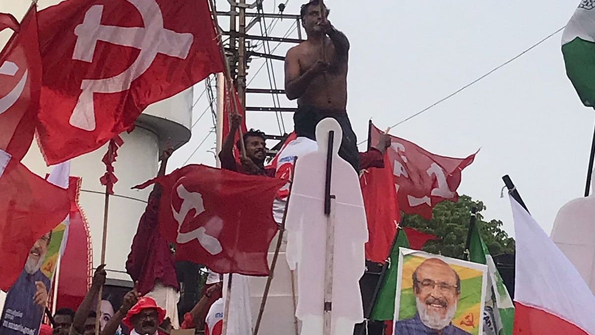 CPI(M) workers hoist party flags during the campaign