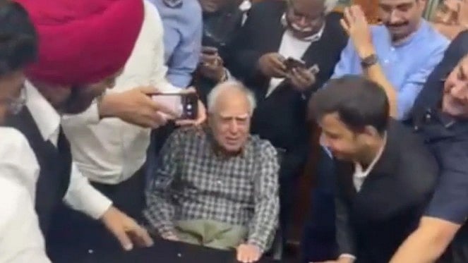Kapil Sibal celebrates with colleagues in New Delhi on 16 May (photo: PTI)