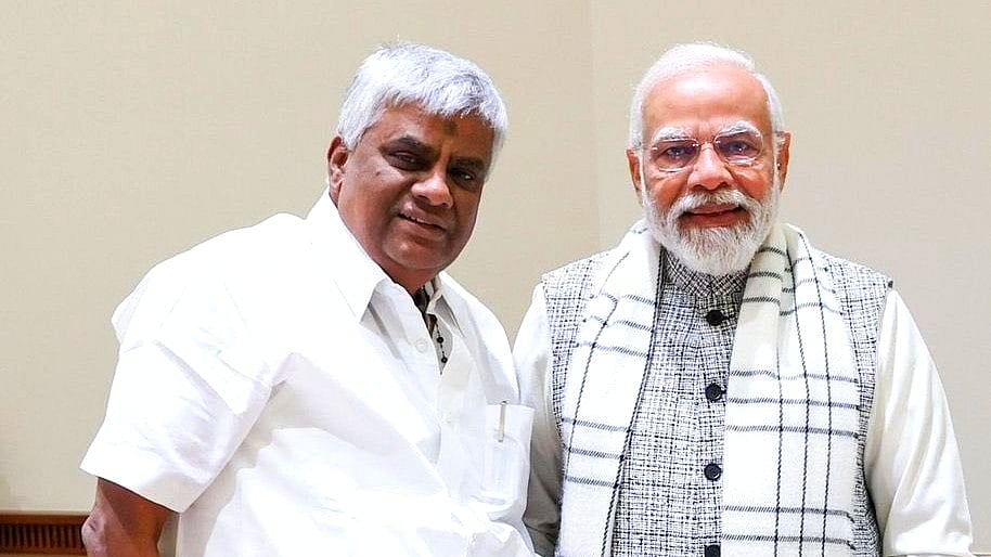 Prajwal's father H.D. Revanna (left) with PM Narendra Modi (photo: @Jairam_Ramesh/X)