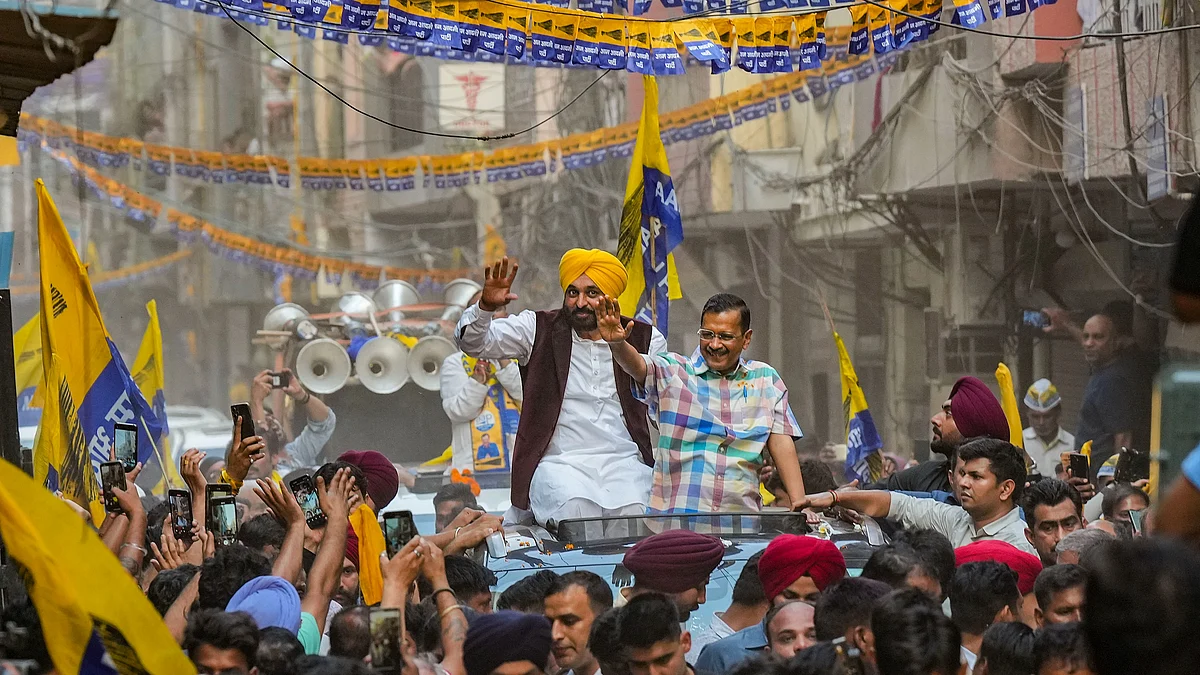 Arvind Kejriwal with Punjab chief minister Bhagwant Mann during a road show for Lok Sabha elections, at Moti Nagar in New Delhi, Sunday, 12 May (photo: PTI)