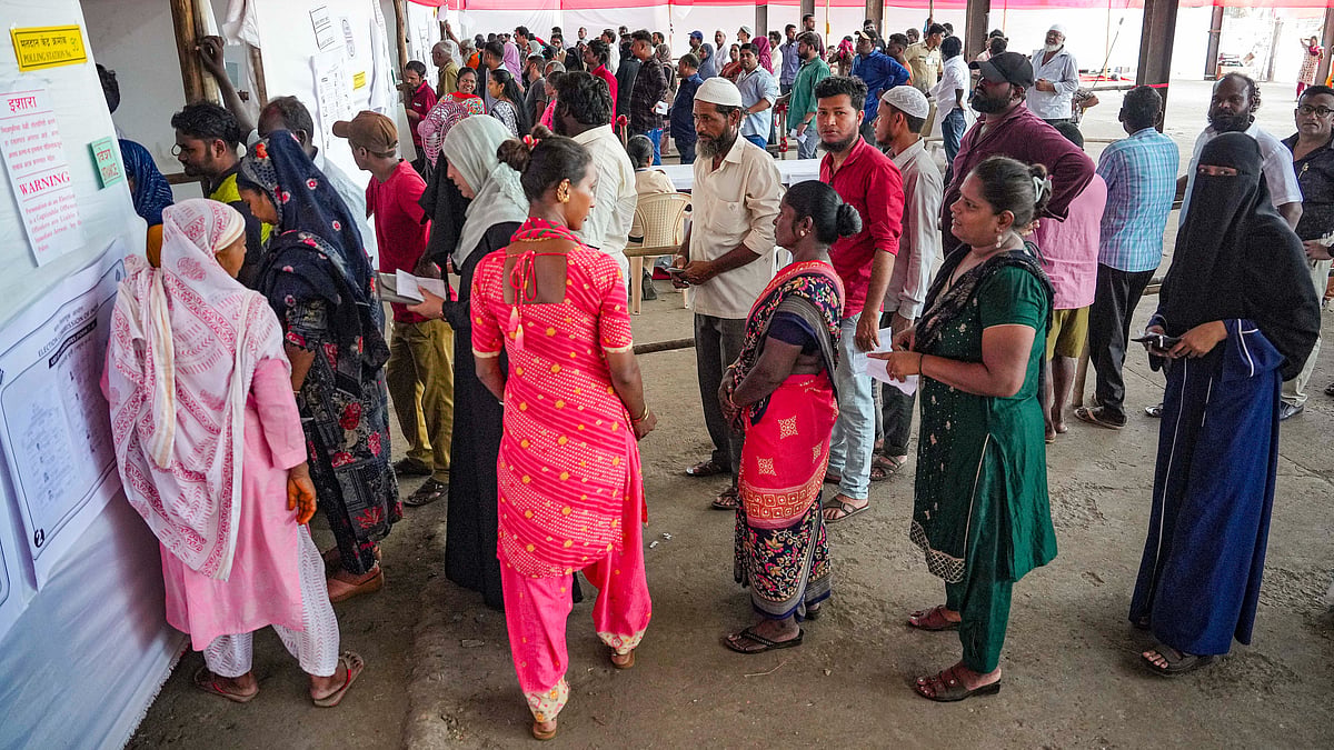Voters wait outside a polling station in Mumbai on 20 May