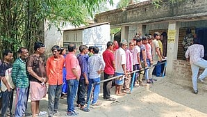 Voters wait outside a polling booth in Jhargram on 25 May (photo: IANS)