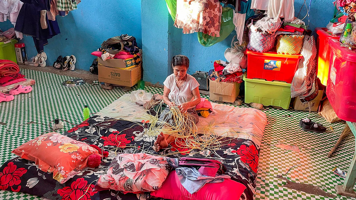 Woman making baskets to earn a living at a relief camp in Imphal (photo: PTI)