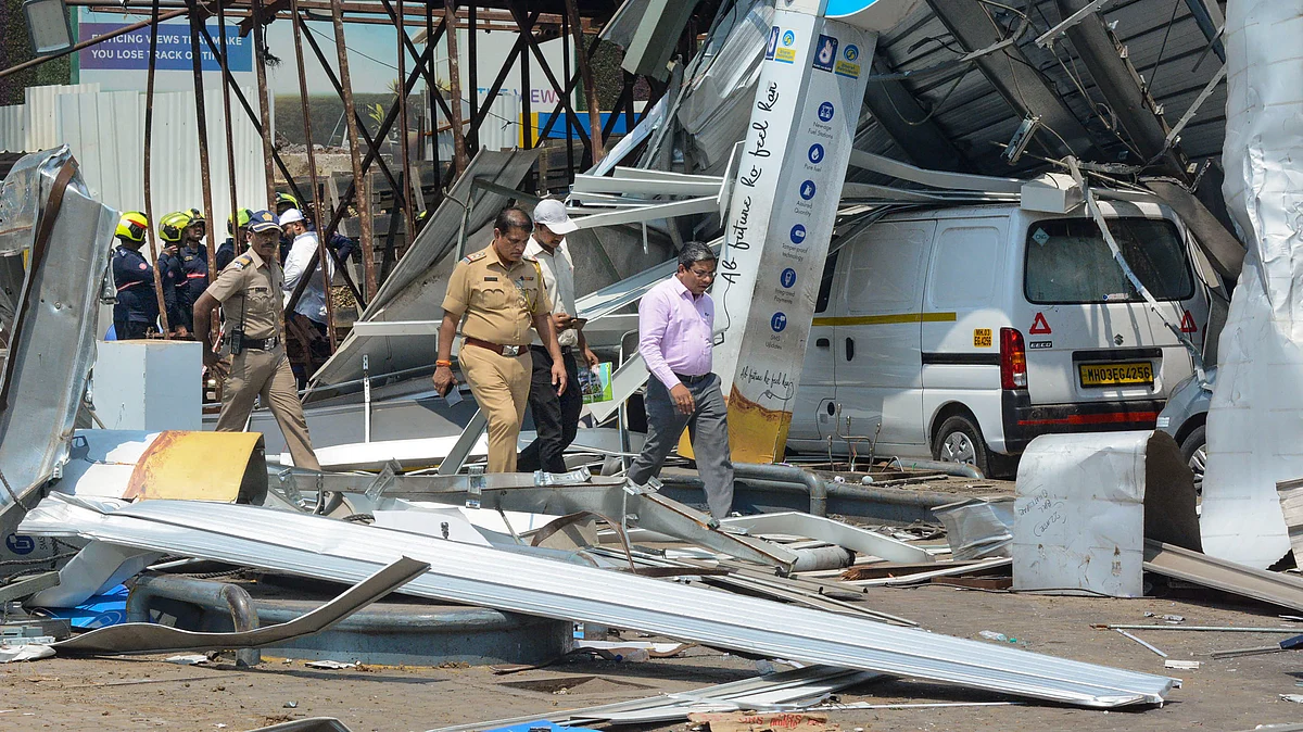 Police and fire brigade personnel at the hoarding collapse site in Mumbai on 14 May (photo: PTI)