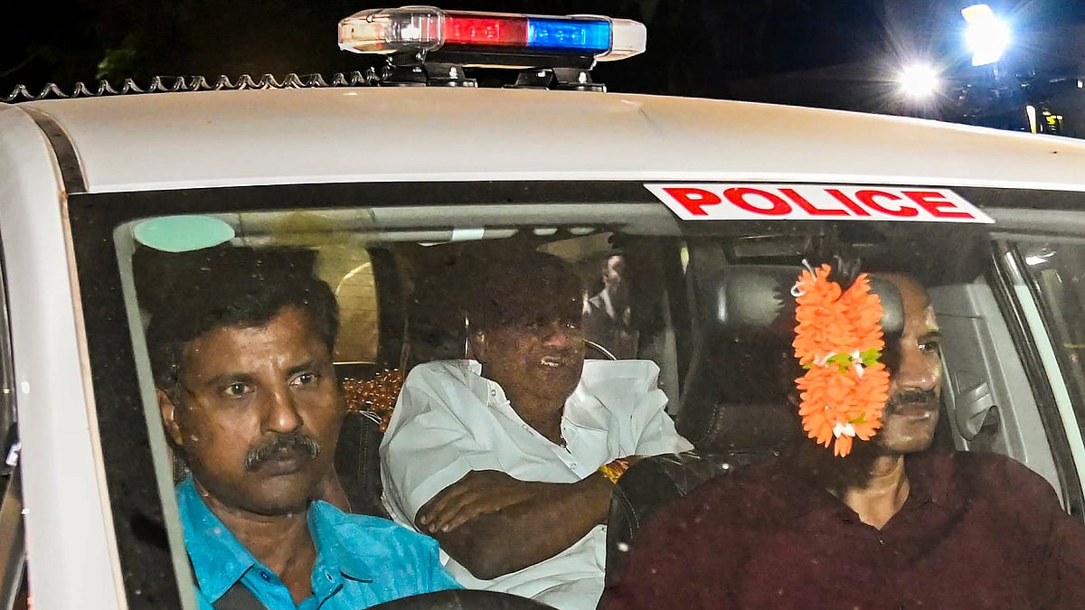 H.D. Revanna with SIT officials in Bengaluru on 4 May (photo: PTI)