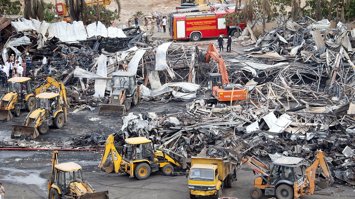Debris being removed from the accident site in Rajkot on 26 May (photo: PTI)