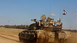 An Israeli tank is seen near the Shalom Kerem crossing in southern Israel on 6 May (photo: IANS)