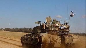 An Israeli tank is seen near the Shalom Kerem crossing in southern Israel on 6 May (photo: IANS)