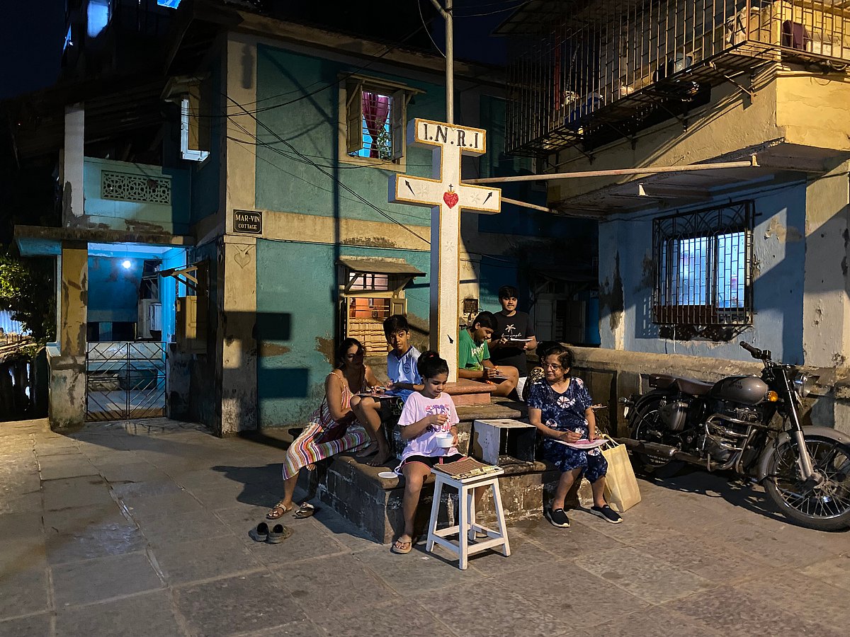 Lakin (green shirt) and other children playing 'Housie' after the eveing's rosary prayer
