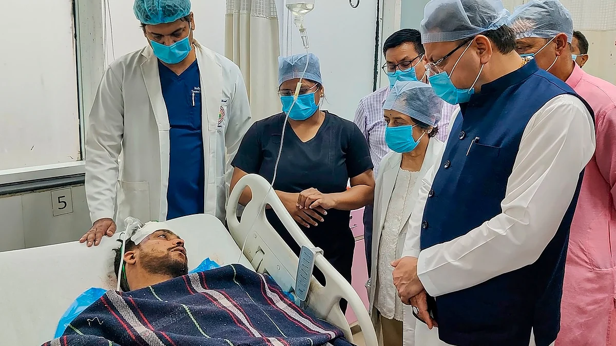 Uttarakhand CM Pushkar Singh Dhami meets an injured person in Rudraprayag on 15 June (photo: PTI)