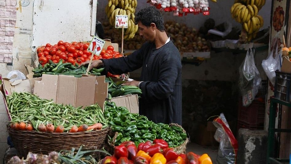 A man sells vegetables at a market.