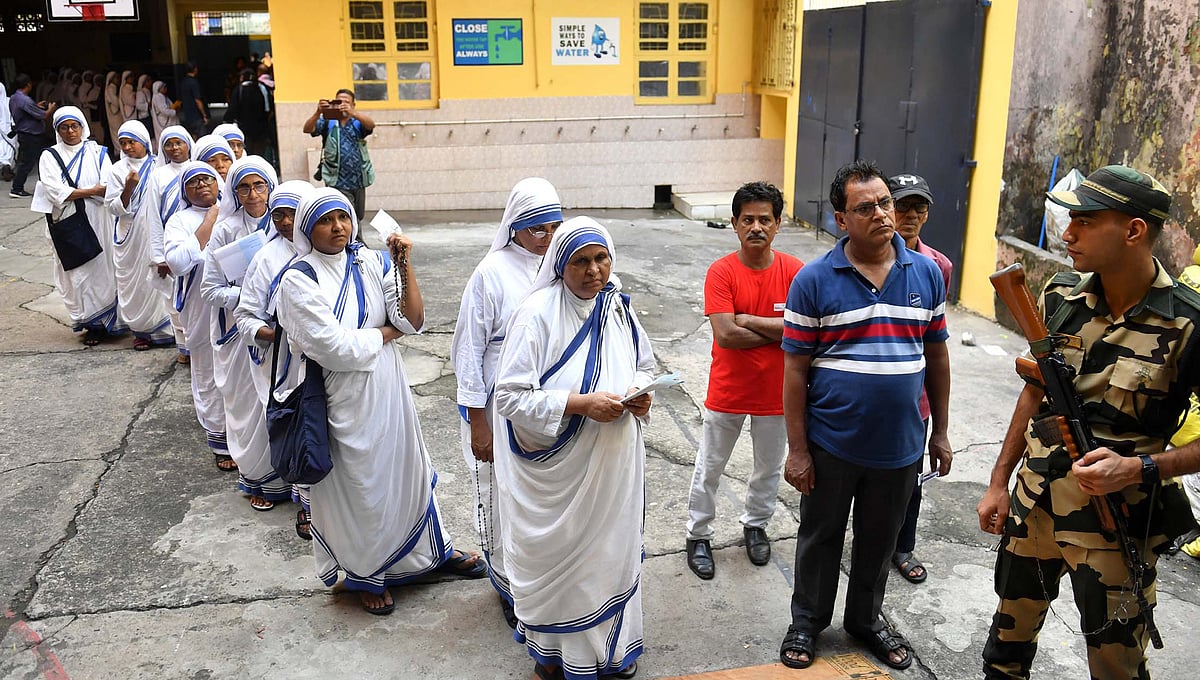 Sisters from Mother Teresa's Missionaries of Charity queue up to vote in Kolkata