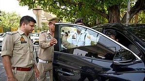 Police officers check a vehicle in Uttar Pradesh (photo: IANS)